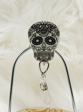 Load image into Gallery viewer, Glow in the Collapsable Dark Sugar Skull Badge Reel
